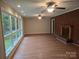 Spacious living room featuring hardwood floors, large windows, and a brick fireplace at 520 Crestview Dr, Albemarle, NC 28001
