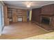 Spacious living room boasting a brick fireplace, built-in shelving, hardwood floors, and a ceiling fan at 520 Crestview Dr, Albemarle, NC 28001