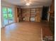 Cozy living room with built in bookshelves, hardwood floors and sliding glass door to the backyard at 520 Crestview Dr, Albemarle, NC 28001