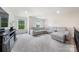 Spacious bonus room with plush carpeting and a large sectional couch at 5366 Meadowcroft Way, Fort Mill, SC 29708
