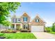 Charming brick home with a well-manicured lawn and a bright yellow front door at 5366 Meadowcroft Way, Fort Mill, SC 29708
