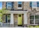 Inviting front porch with stylish columns and a vibrant yellow door at 5366 Meadowcroft Way, Fort Mill, SC 29708