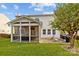 Spacious backyard featuring a screened porch, brick patio, and lush lawn, perfect for outdoor living and entertaining at 6119 Castlecove Rd, Charlotte, NC 28278