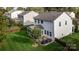 View of the grassy backyard with a patio area, grill, and privacy fence at 6119 Castlecove Rd, Charlotte, NC 28278
