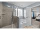 Bright bathroom featuring a glass shower and a soaking tub beside a window, creating a spa-like experience at 6119 Castlecove Rd, Charlotte, NC 28278