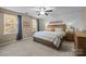 Serene bedroom with a king-sized bed, shiplap accent wall, and natural light, perfect for relaxation at 6119 Castlecove Rd, Charlotte, NC 28278