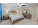 Beautiful bedroom featuring neutral colors, matching dressers, and a ceiling fan, creating a calming and elegant space at 6119 Castlecove Rd, Charlotte, NC 28278