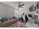 Bright office space with a comfortable sofa, multiple screens, and workout equipment, perfect for a productive and healthy lifestyle at 6119 Castlecove Rd, Charlotte, NC 28278
