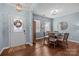 Cozy dining room featuring stylish lighting, hardwood floors, and a decorative wall mirror at 6119 Castlecove Rd, Charlotte, NC 28278