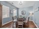 Cozy dining room featuring a stylish light fixture, hardwood floors, and a decorative wall mirror at 6119 Castlecove Rd, Charlotte, NC 28278