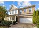 Charming two-story home with a brick and vinyl exterior, featuring an attached two-car garage at 6119 Castlecove Rd, Charlotte, NC 28278