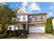 Charming two-story home with a brick and vinyl exterior, featuring an attached two-car garage at 6119 Castlecove Rd, Charlotte, NC 28278