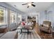 Spacious living room with large windows, hardwood floors, and open access to the kitchen at 6119 Castlecove Rd, Charlotte, NC 28278