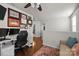 Loft space featuring a desk setup, comfortable seating, and hardwood floors, perfect for work or relaxation at 6119 Castlecove Rd, Charlotte, NC 28278