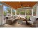 Cozy screened porch with ample seating, perfect for relaxing and enjoying the outdoors in comfort and style at 6119 Castlecove Rd, Charlotte, NC 28278