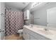 Traditional bathroom offers a double vanity with a patterned shower curtain and neutral palette at 6309 Crosshall Pl, Waxhaw, NC 28173