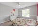 Charming bedroom with floral bedding, a ceiling fan, and white dresser at 6309 Crosshall Pl, Waxhaw, NC 28173