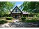 A clubhouse with a Tudor-style facade surrounded by landscaping, offering a welcoming community gathering space at 6309 Crosshall Pl, Waxhaw, NC 28173