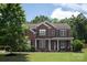 Charming two-story brick home featuring classic shutters, a covered front porch, and a well-manicured lawn at 6309 Crosshall Pl, Waxhaw, NC 28173