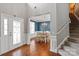 Inviting foyer with hardwood floors leading to a dining room with chandelier at 6309 Crosshall Pl, Waxhaw, NC 28173