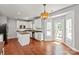 Bright kitchen with white cabinets, granite countertops, stainless steel appliances, and a view of the patio at 6309 Crosshall Pl, Waxhaw, NC 28173