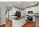 Spacious kitchen featuring white cabinets, granite countertops, stainless steel appliances, and a kitchen island at 6309 Crosshall Pl, Waxhaw, NC 28173