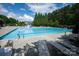A large, community pool with lap lanes, lounge chairs, and a slide in a fenced recreation area at 6309 Crosshall Pl, Waxhaw, NC 28173
