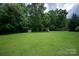 Spacious backyard with playset, storage shed, and mature shade trees at 6309 Crosshall Pl, Waxhaw, NC 28173
