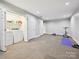 Finished basement includes a laundry area and open space with exercise equipment, perfect for Gathering activities at 6647 Gaywind Dr, Charlotte, NC 28226