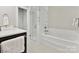 Bright bathroom featuring a glass enclosed shower, soaking tub, and modern fixtures at 6647 Gaywind Dr, Charlotte, NC 28226