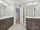 Elegant bathroom with dual vanities, modern lighting, and a glass-enclosed shower at 6647 Gaywind Dr, Charlotte, NC 28226