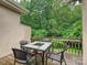 Outdoor deck with a table and chairs, surrounded by lush green trees for privacy at 6647 Gaywind Dr, Charlotte, NC 28226