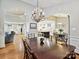 Open-concept dining area with chandelier and access to the kitchen and living spaces at 6647 Gaywind Dr, Charlotte, NC 28226