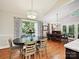 Elegant dining area with hardwood floors, chandelier lighting, and access to outdoor space at 6647 Gaywind Dr, Charlotte, NC 28226