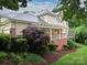 Charming home with a lush landscaped yard and a covered porch, perfect for relaxing outdoors at 6647 Gaywind Dr, Charlotte, NC 28226