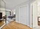 Hallway view to the bedroom with natural light, featuring hardwood floors and access to the bathroom at 6647 Gaywind Dr, Charlotte, NC 28226