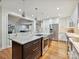 Spacious kitchen with a large marble island, stainless steel appliances, and white cabinets at 6647 Gaywind Dr, Charlotte, NC 28226