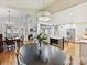 This open concept shows a spacious kitchen with a marble island and white cabinets, adjacent to the dining and living spaces at 6647 Gaywind Dr, Charlotte, NC 28226