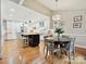 Beautiful kitchen and breakfast nook with white cabinets, dark island, stainless steel appliances, and hardwood floors at 6647 Gaywind Dr, Charlotte, NC 28226