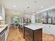 Gourmet kitchen with stainless steel appliances, marble island, and open layout to dining area at 6647 Gaywind Dr, Charlotte, NC 28226