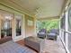 Relaxing screened porch with comfortable seating and a ceiling fan at 6647 Gaywind Dr, Charlotte, NC 28226