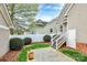 A backyard featuring manicured landscaping, a privacy fence, and a small patio area at 6705 E Douglas Park Dr, Huntersville, NC 28078