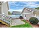 Cozy backyard with a small patio, partial fence, and a charming yard at 6705 E Douglas Park Dr, Huntersville, NC 28078