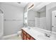 Bathroom featuring a double sink vanity, large mirror, and neutral colored walls at 6705 E Douglas Park Dr, Huntersville, NC 28078