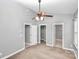 Bright bedroom with closet and attached bathroom featuring a ceiling fan and neutral walls at 6705 E Douglas Park Dr, Huntersville, NC 28078