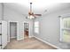 Cozy bedroom with neutral walls, a ceiling fan, and view into an attached bathroom at 6705 E Douglas Park Dr, Huntersville, NC 28078