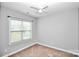 Neutral bedroom features a large window and ceiling fan for comfort at 6705 E Douglas Park Dr, Huntersville, NC 28078