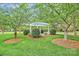 Beautiful common area with a gazebo, trimmed bushes, and lush green grass at 6705 E Douglas Park Dr, Huntersville, NC 28078
