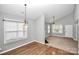 Dining room featuring wood floors, large window, and an open view to the living room at 6705 E Douglas Park Dr, Huntersville, NC 28078