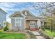 Charming home featuring a yellow front door, landscaped yard, and inviting curb appeal at 6705 E Douglas Park Dr, Huntersville, NC 28078